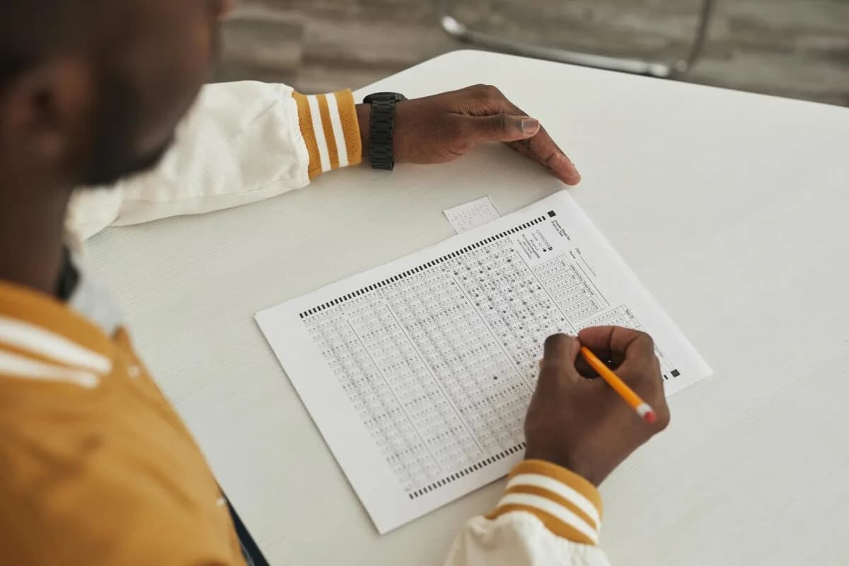 Man taking ACT test on paper.