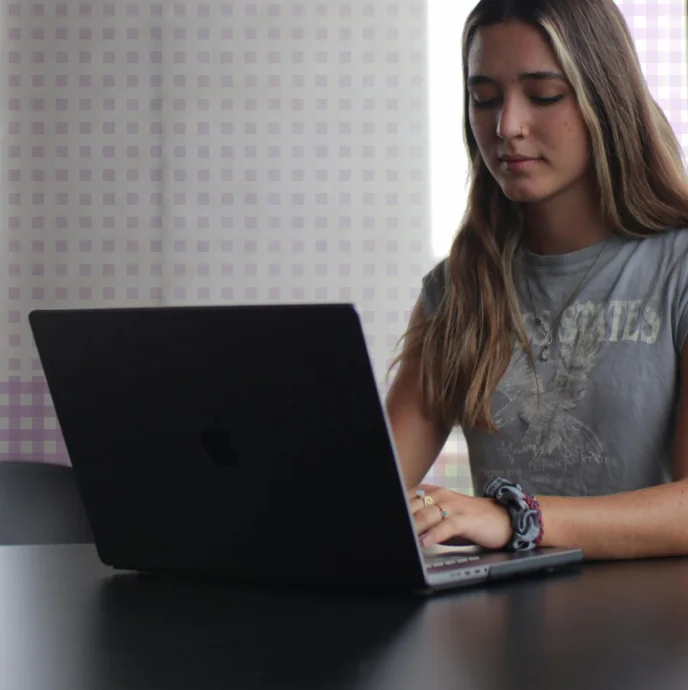 A teen studying on a laptop at home — SAT & ACT study habits guide for parents